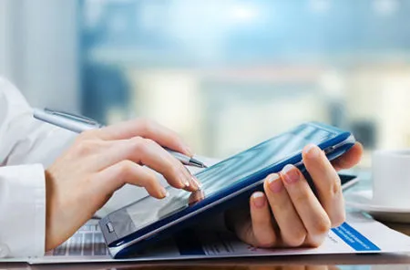 person using a tablet to fill out patient registration
